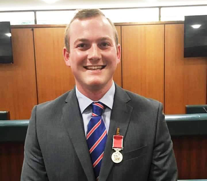 Adam Black, a McGuire Programme member, receives the British Empire Medal for his services to raising awareness of stammering.